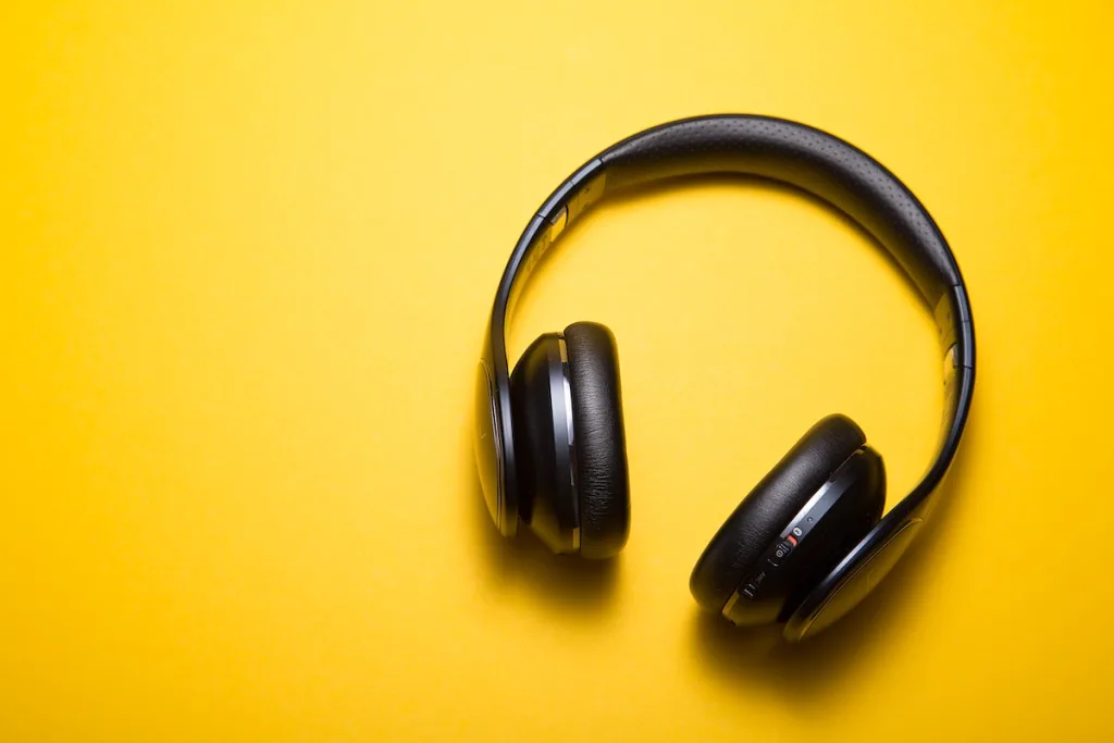 a yellow background with headphones