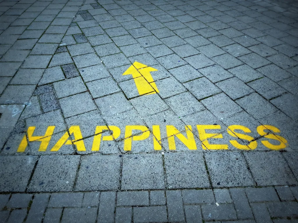 A road that says "happiness" with an arrow in yellow