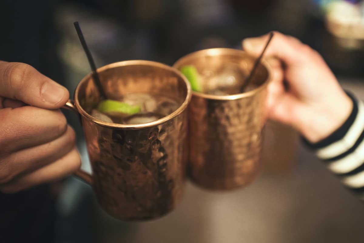 2 hands holding moscow mules together