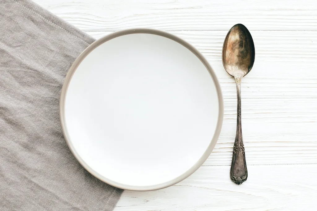 Empty plate with a spoon next to it.