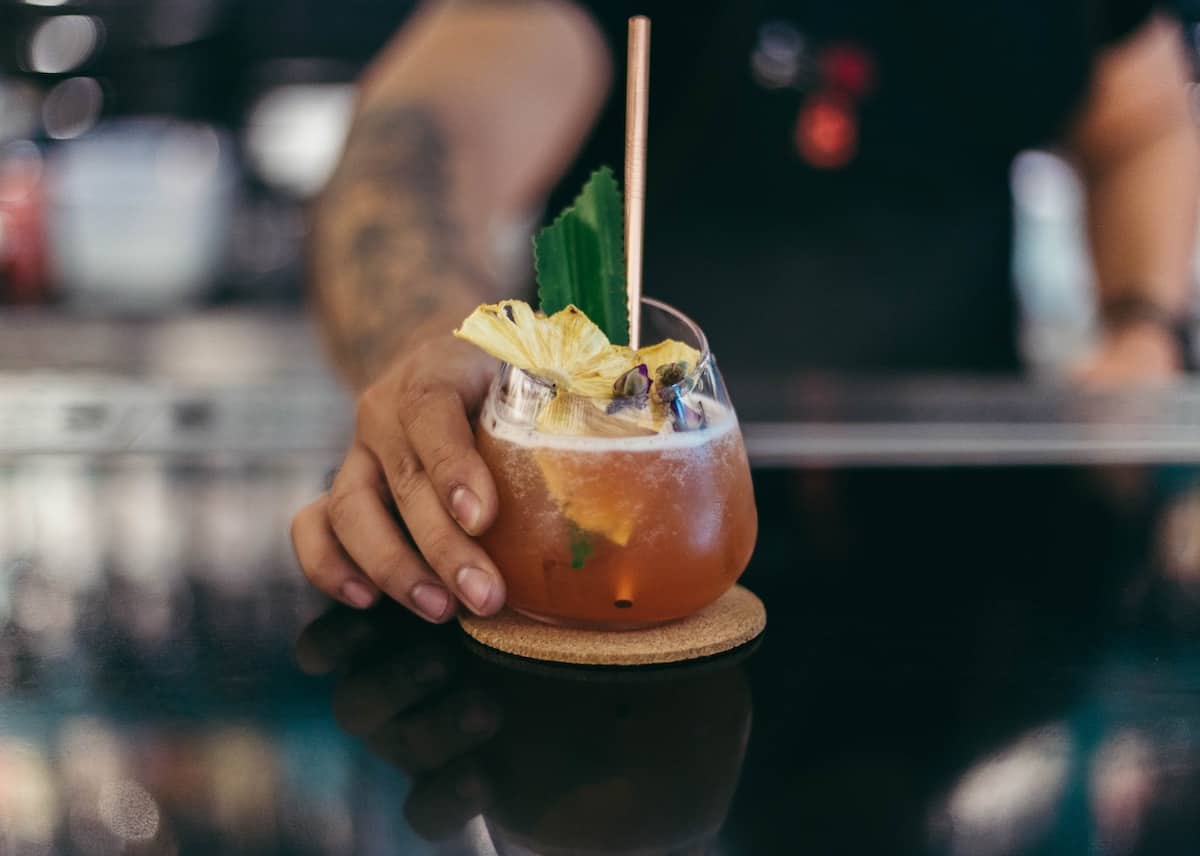 A bartender serving a cocktail