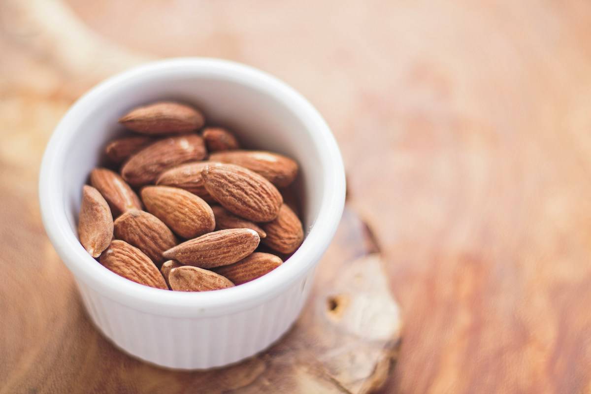 Almonds in a white bowl.