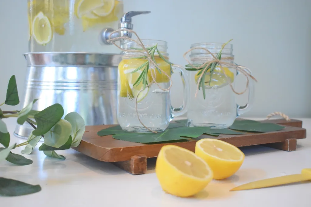 Water in mason jars with lemons and green mint is how to make water taste better