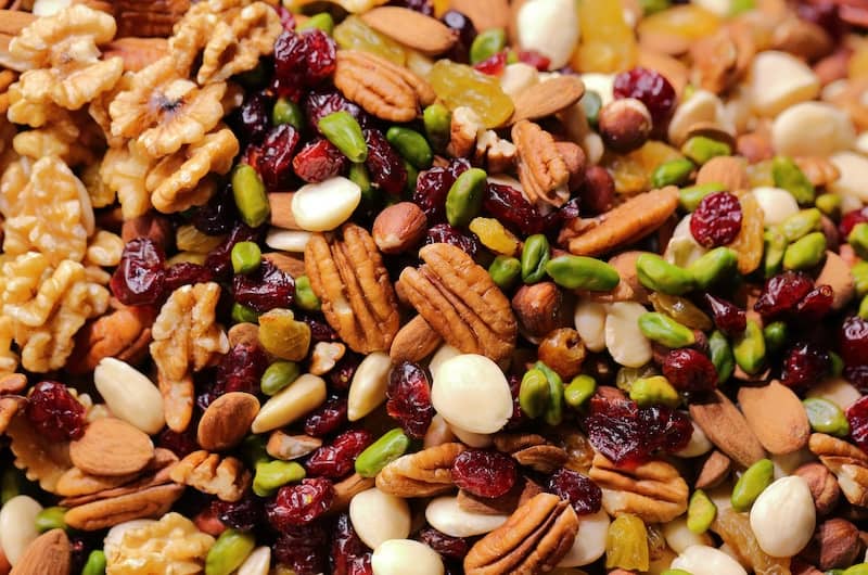 Healthy snacks include nuts. This is a photo of all different kinds with a little dried fruit mixed in.