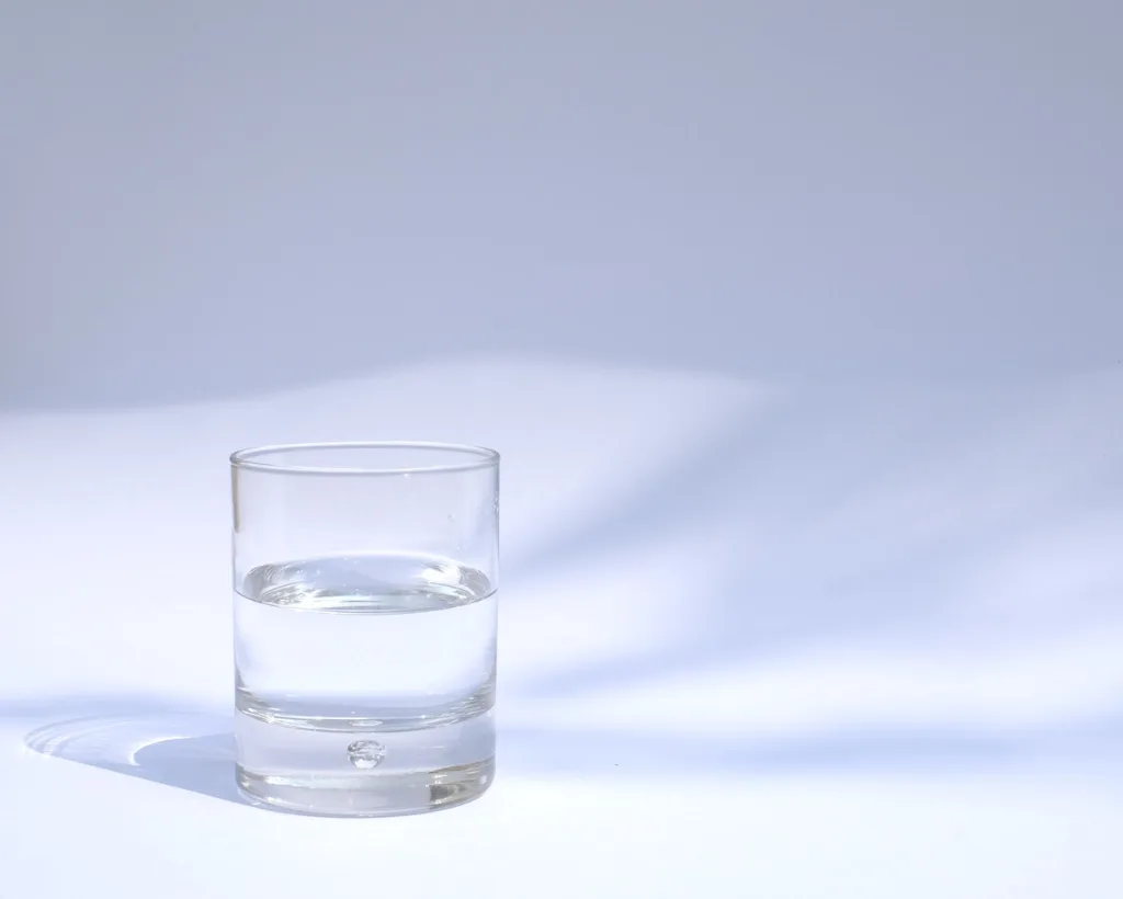 a glass of water against a white background