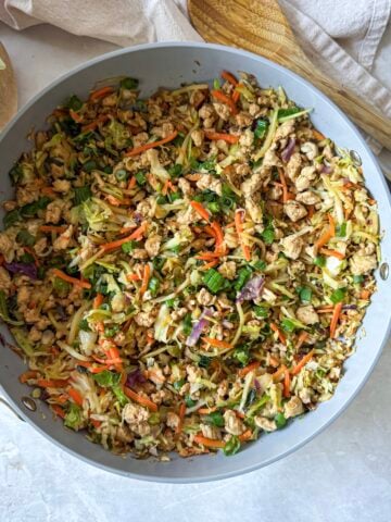 egg roll in a bowl in a skillet overhead view.