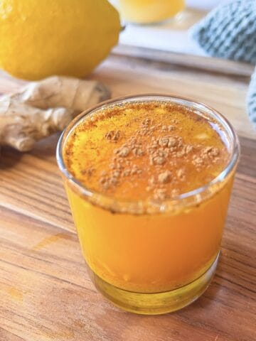 Immunity Booster Shot with Ginger and Turmeric with lemon behind it