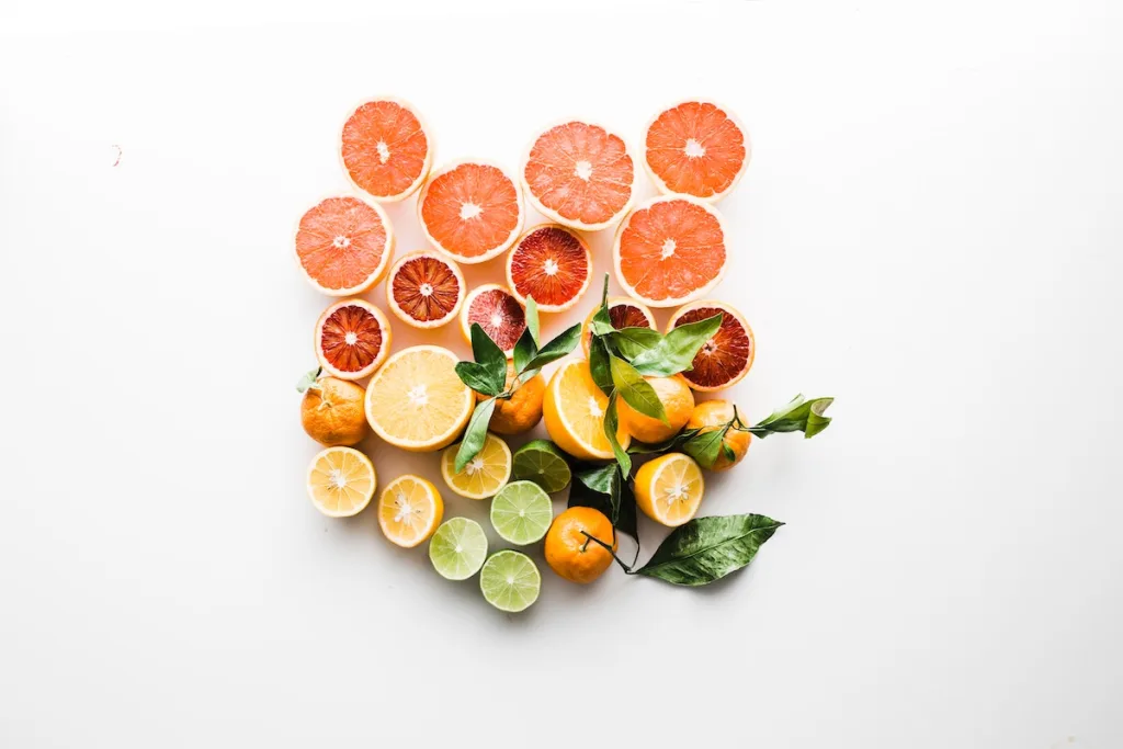 A colorful photo of different kinds of fruits including grapfruit, oranges, and limes