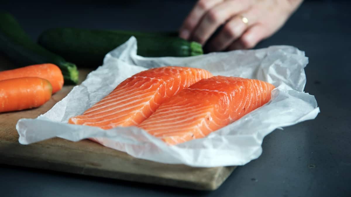 Salmon which is one of the top 10 foods for mental health on a parchment paper
