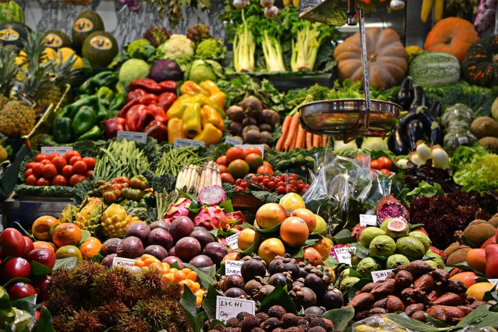 A lot of different fruits and vegetables set up at a market.