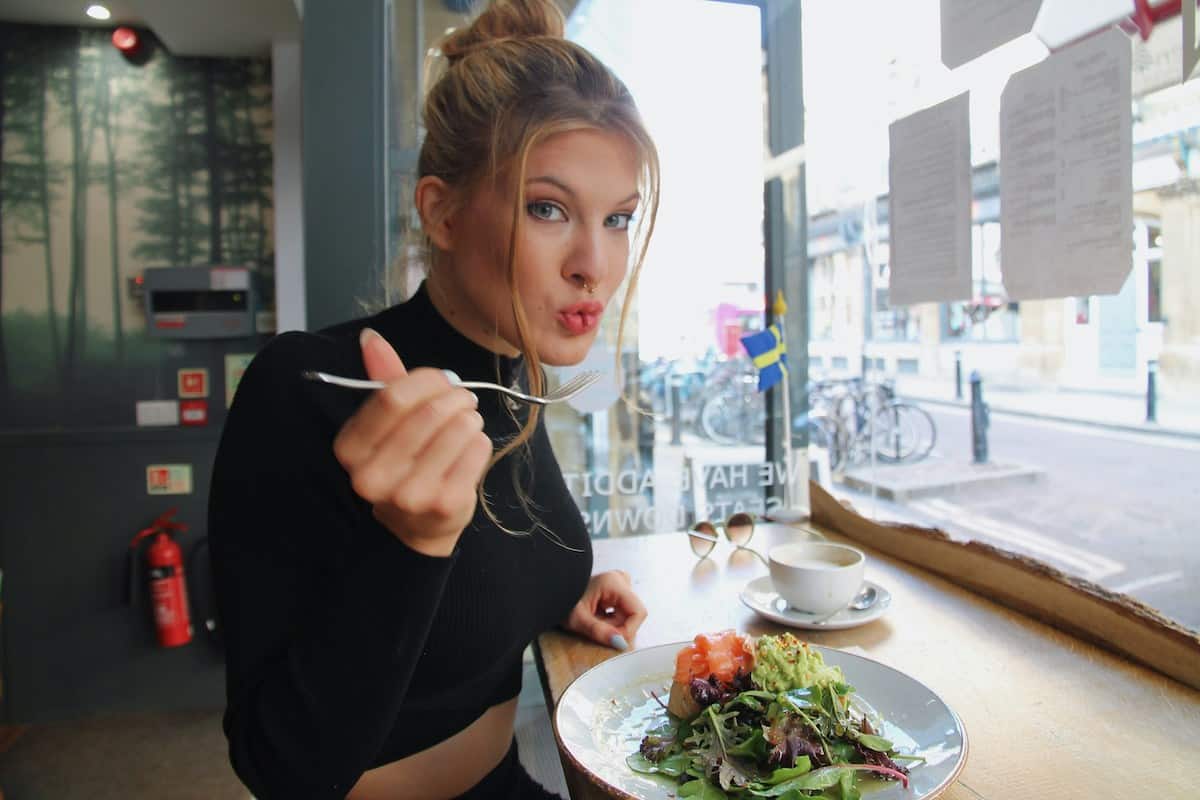 a woman eating a salad.