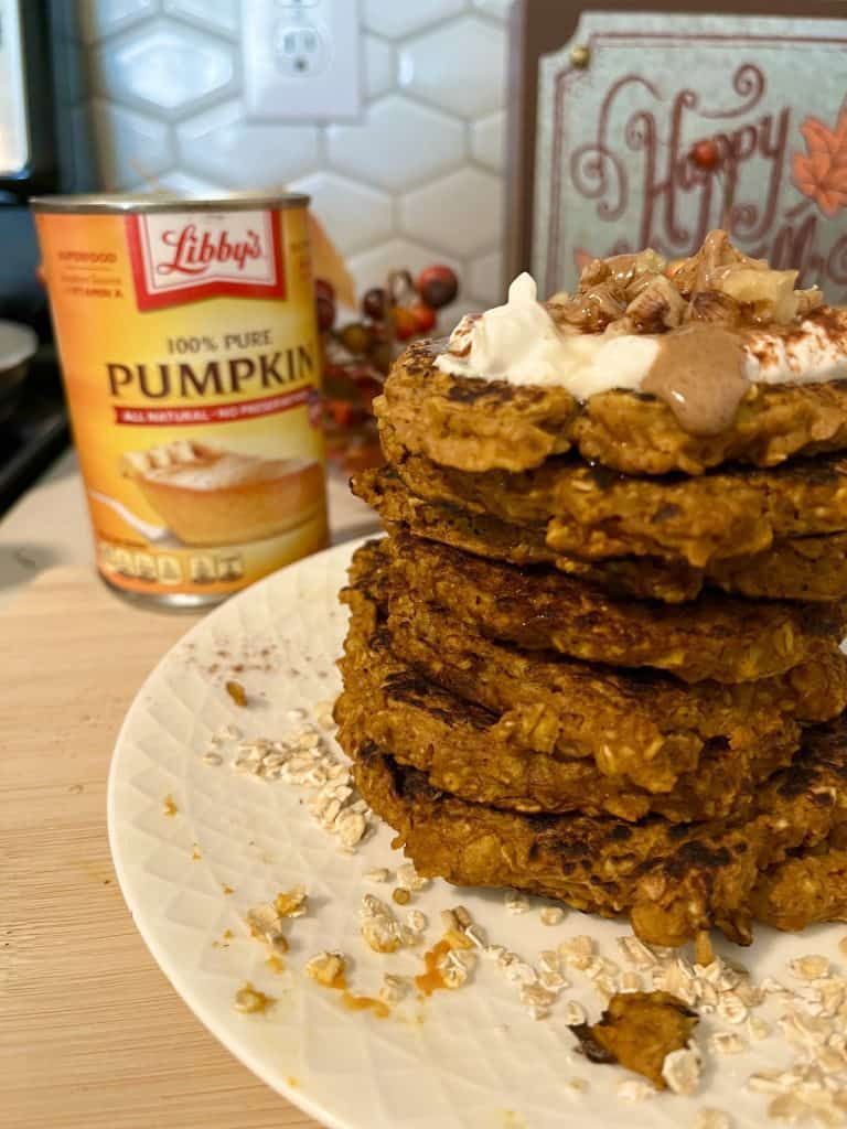 stack of oatmeal pumpkin pancakes with toppings