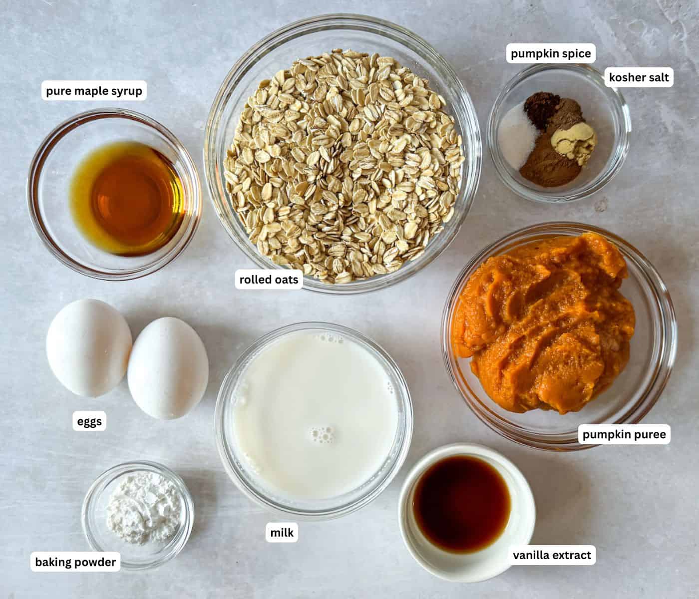pumpkin oatmeal pancake ingredients in separate bowls on a table labeled.