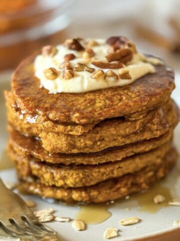 A stack of Pumpkin Oatmeal pancakes on a plate.