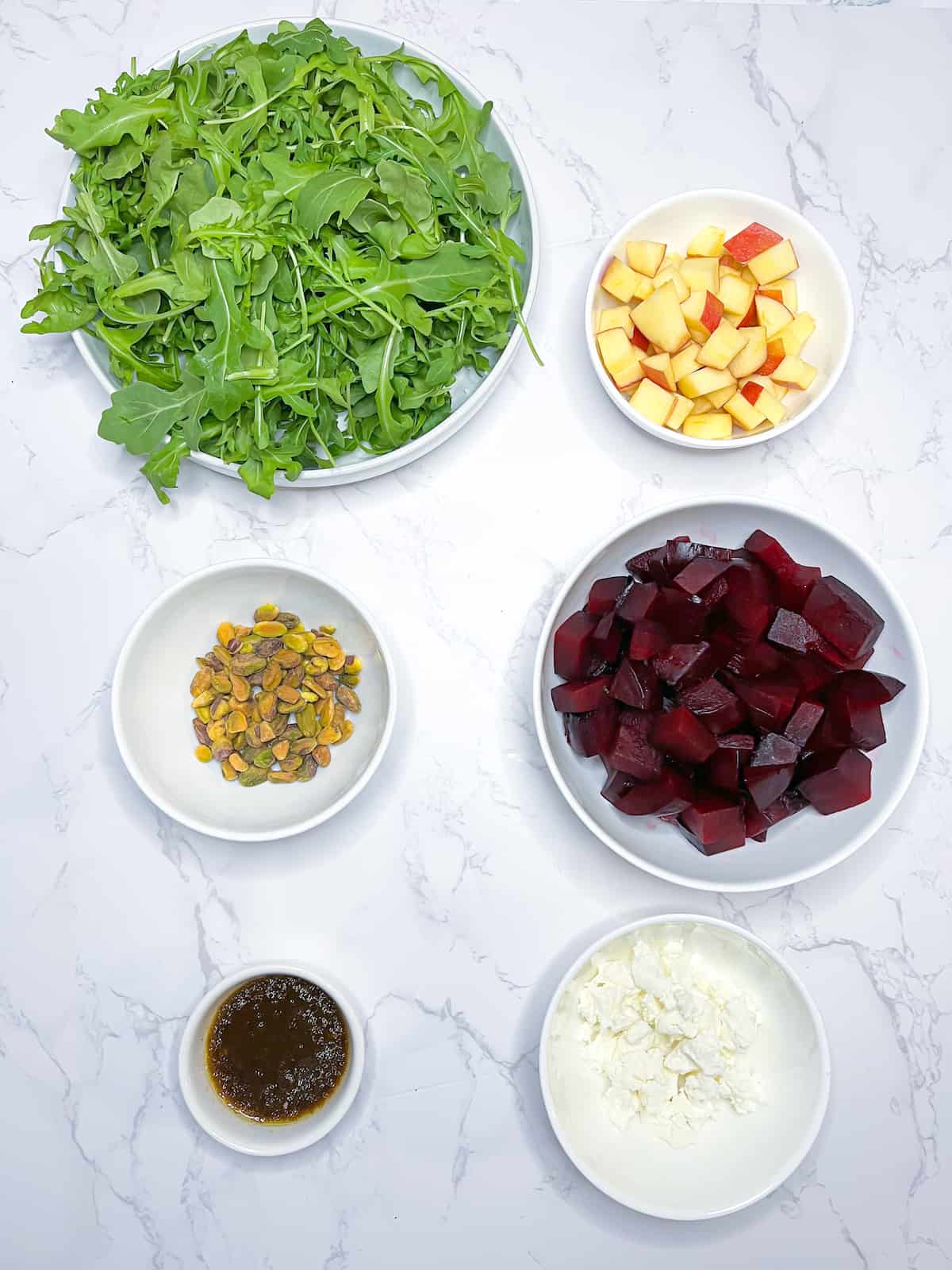 Beet and arugula salad with goat cheese ingredients on a table