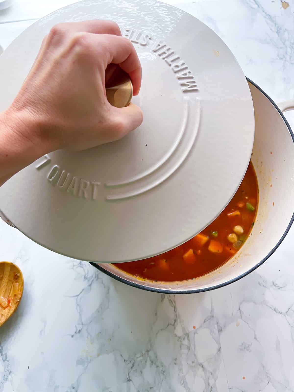 Chickpea soup being covered with a lid