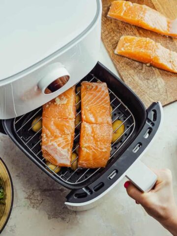 Salmon and potatoes going in an air fryer
