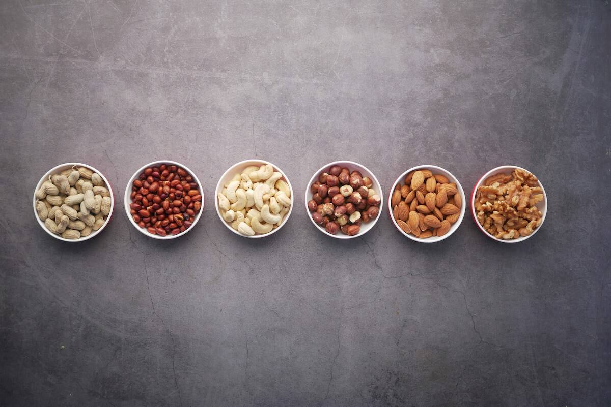 Different kinds of nuts in small bowls