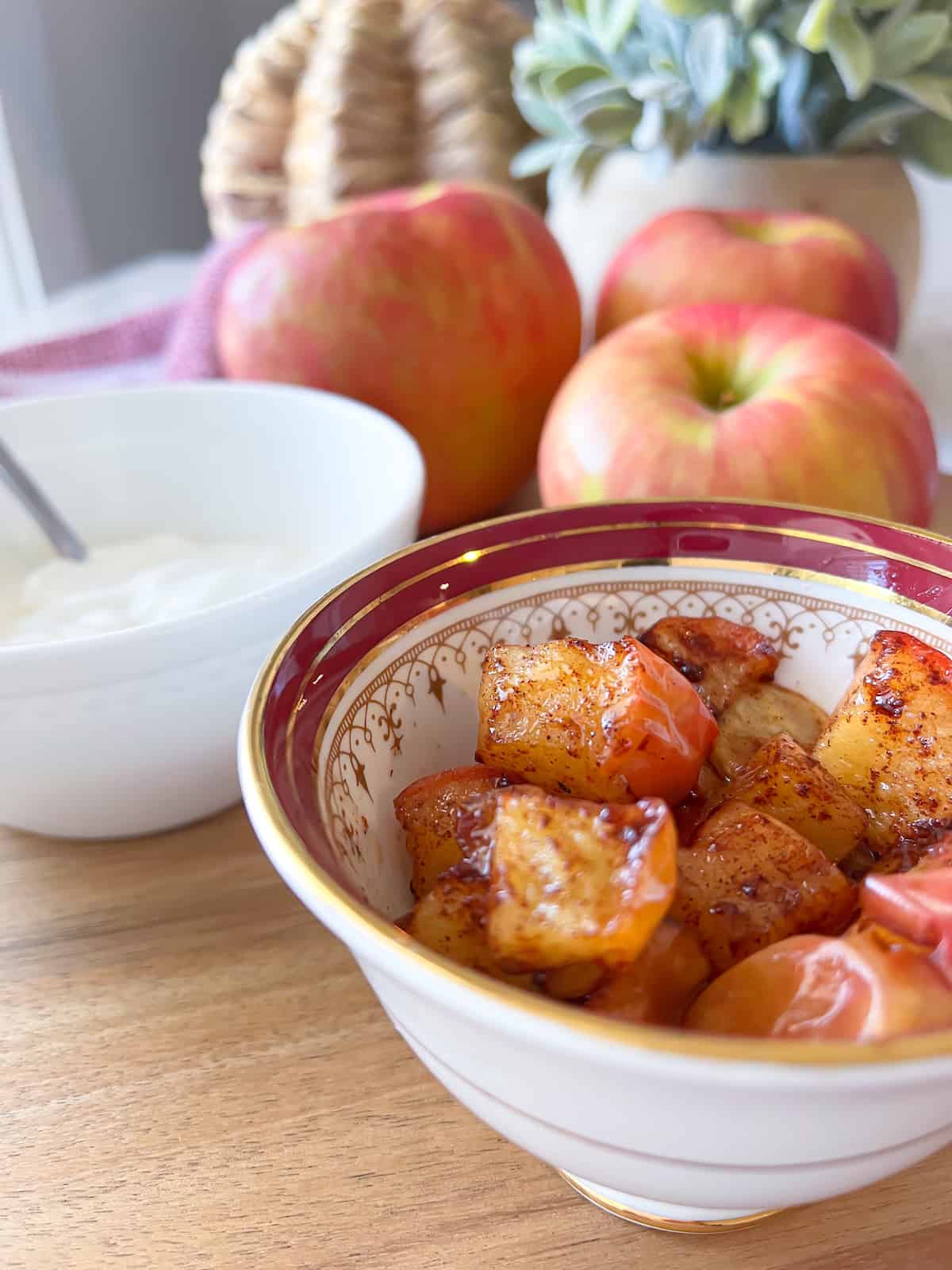 air fryer apples with a bowl of greek yogurt in the background