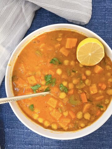 vegan chickpea soup in a bowl with a spoon in it 1200 x 1200