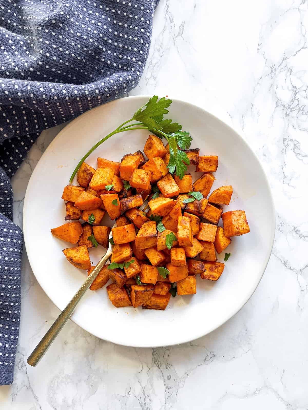 Air fryer sweet potato cubes with parsley