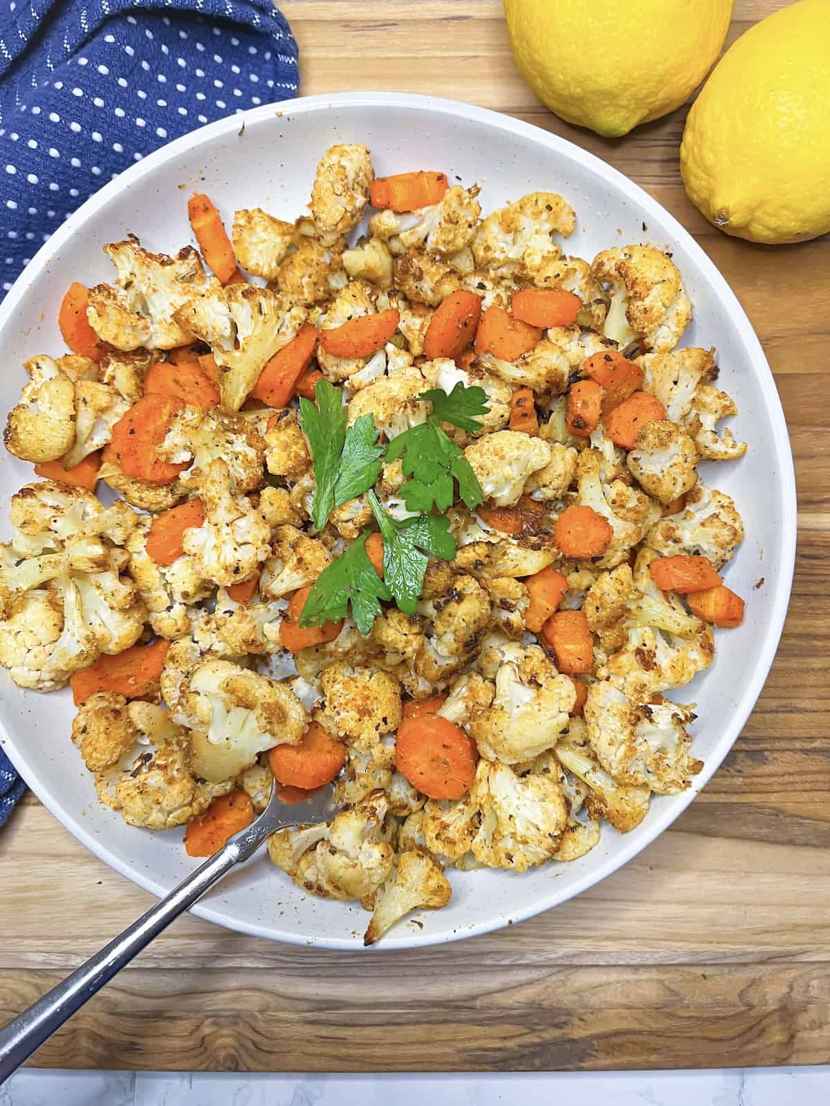 Cauliflower and carrots with lemons in the background