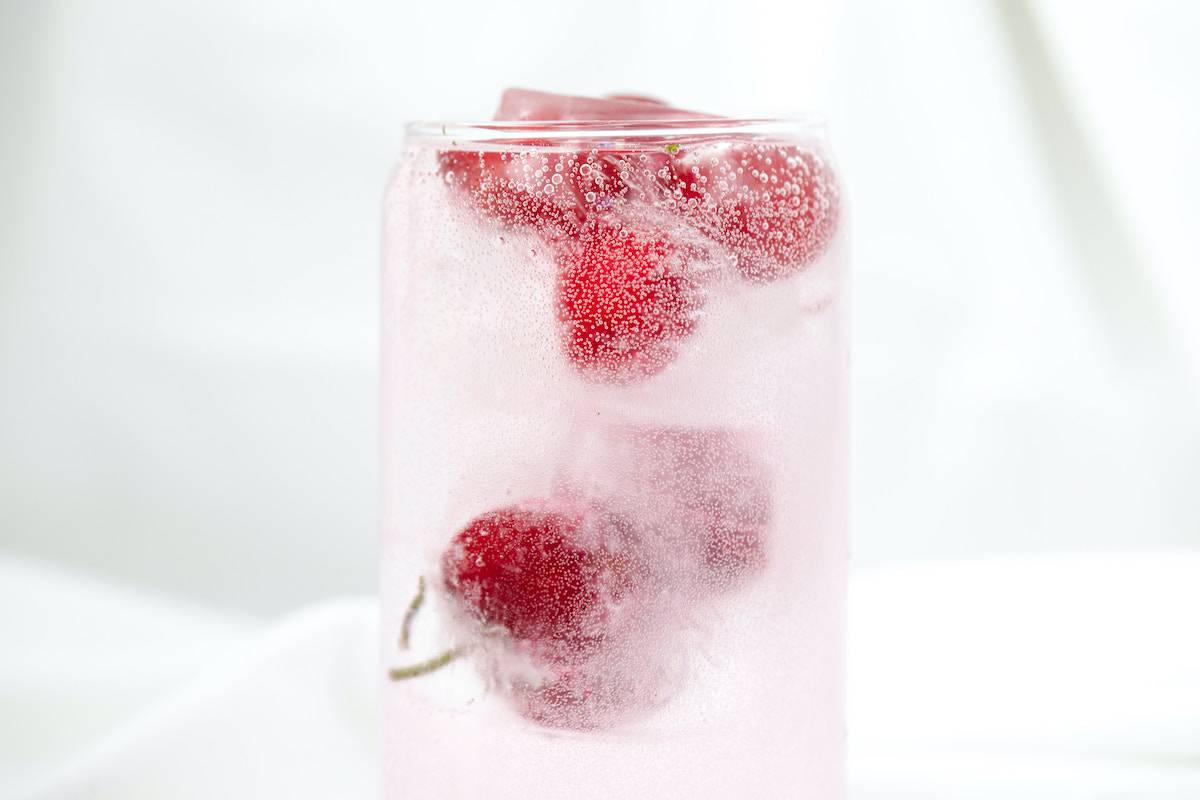 a sparkling water with cherries in it
