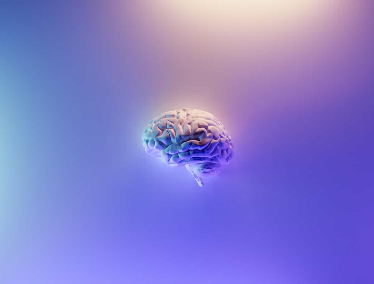 a brain on a purple background because the sober curious movement impacts brain health