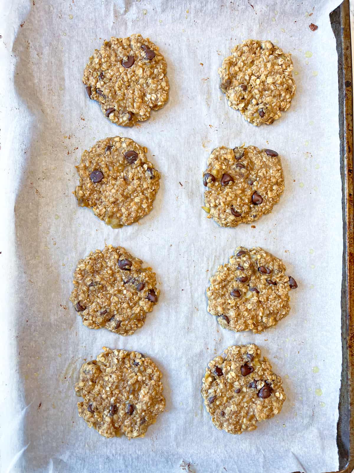 healthy oatmeal banana cookies on a prepared baking sheet with parchment paper
