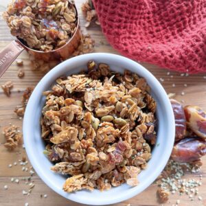 hemp granola with big clusters in a white bowl