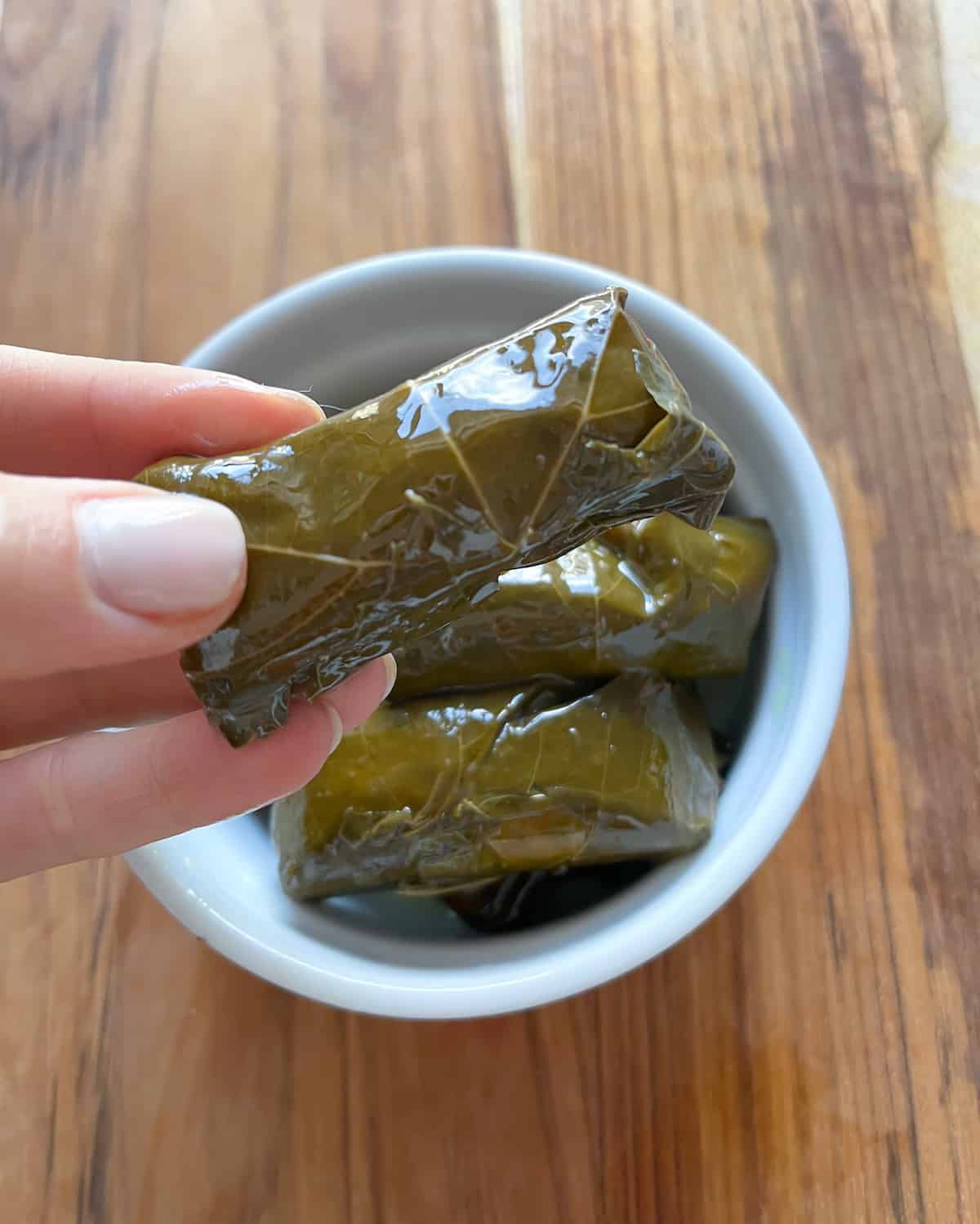 Dolma with a hand holding one up