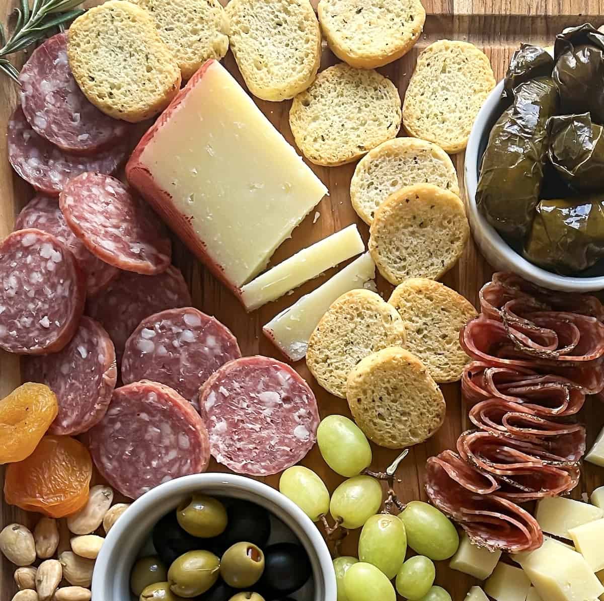 close up of manchego cheese and sausage and olives