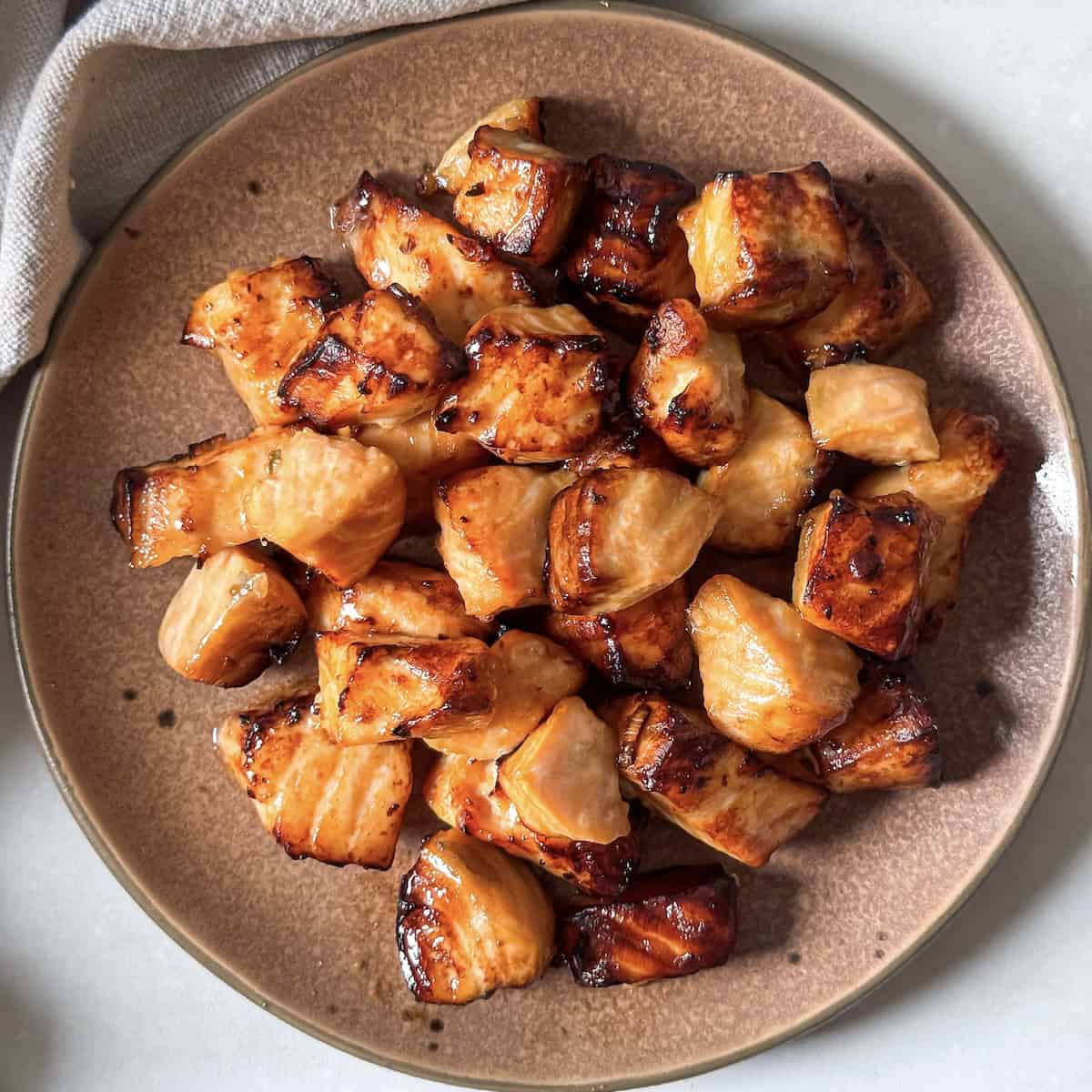 air fryer salmon bites on a plate overhead view.