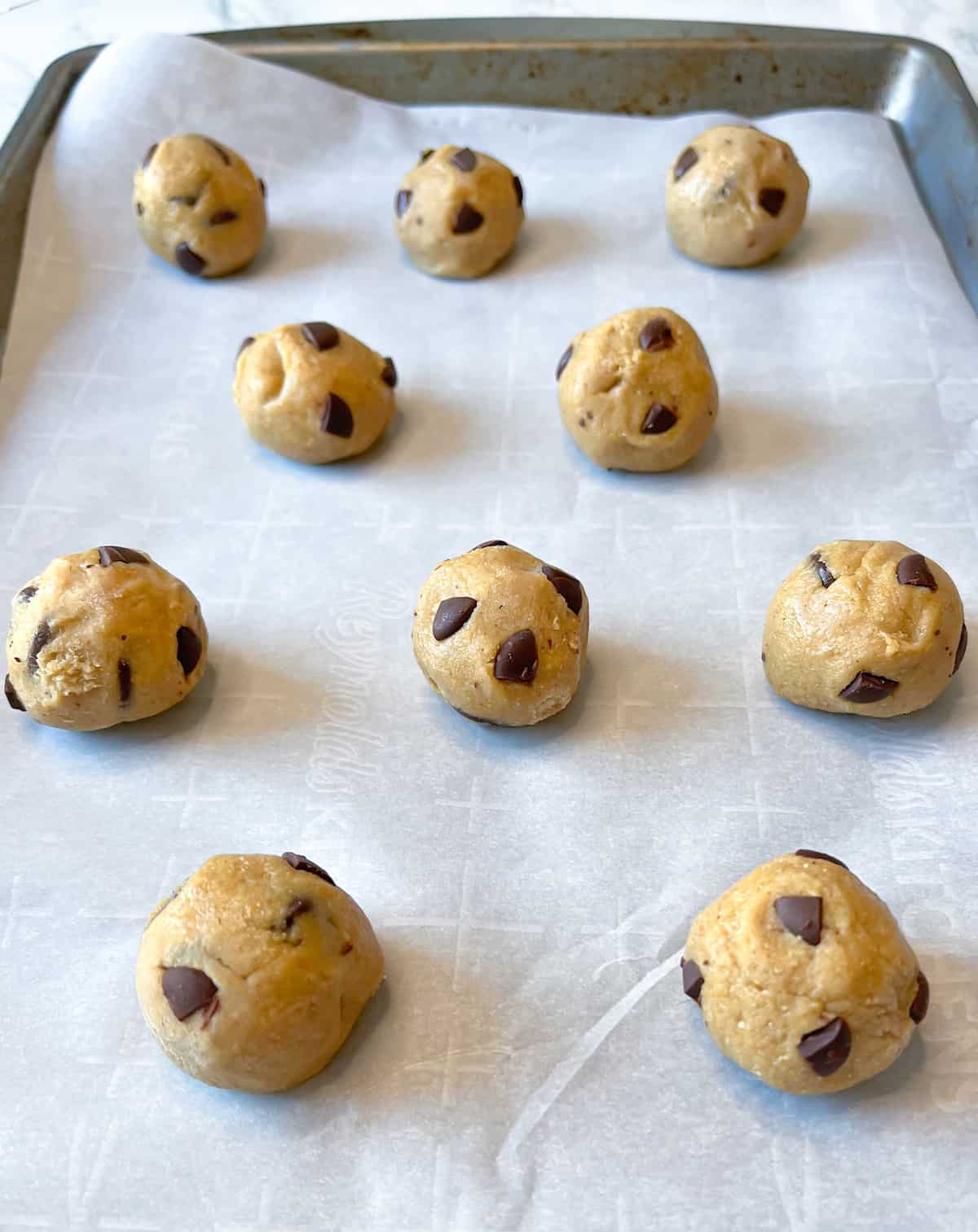 no bake protein cookie dough balls on a baking sheet