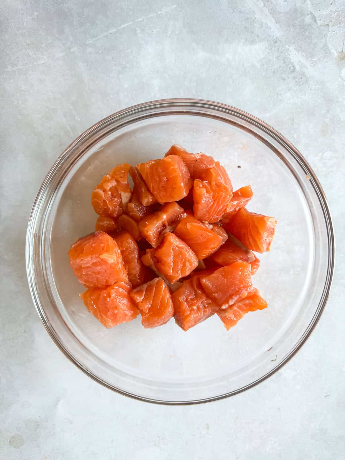 Bite-Sized Salmon Cubes in a glass bowl.
