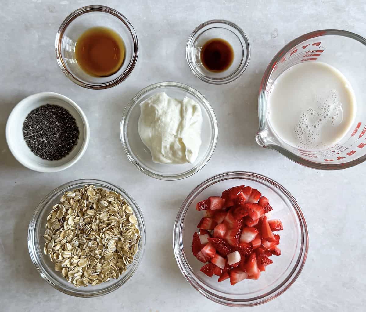 ingredients for strawberries and cream overnight oats on a table.
