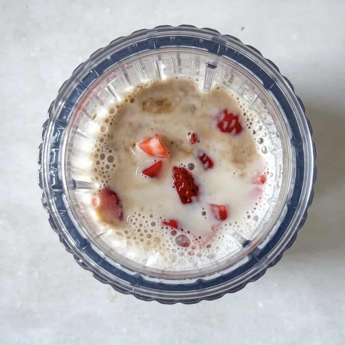 strawberries, milk, vanilla extract, and maple syrup in a blender.