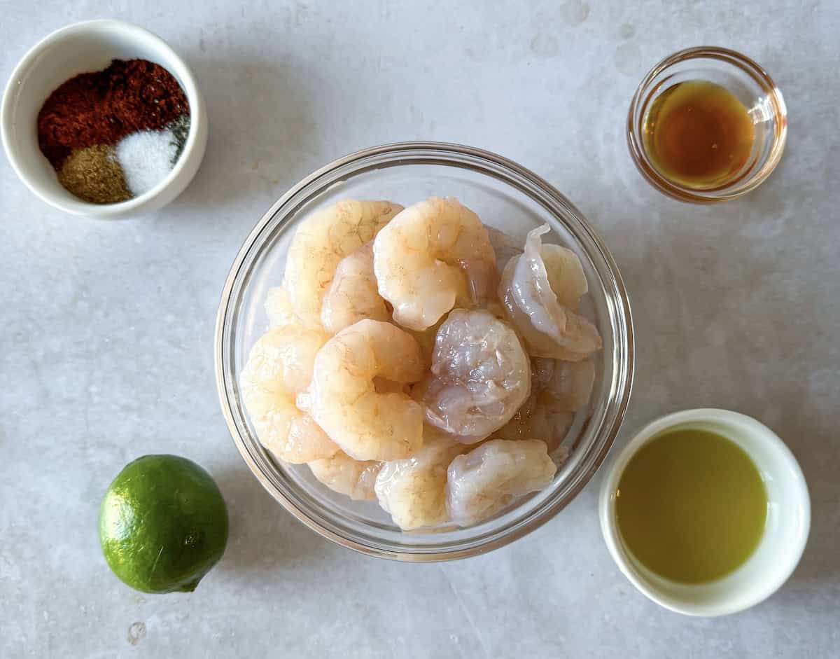 Ingredients for shrimp tacos on a table.