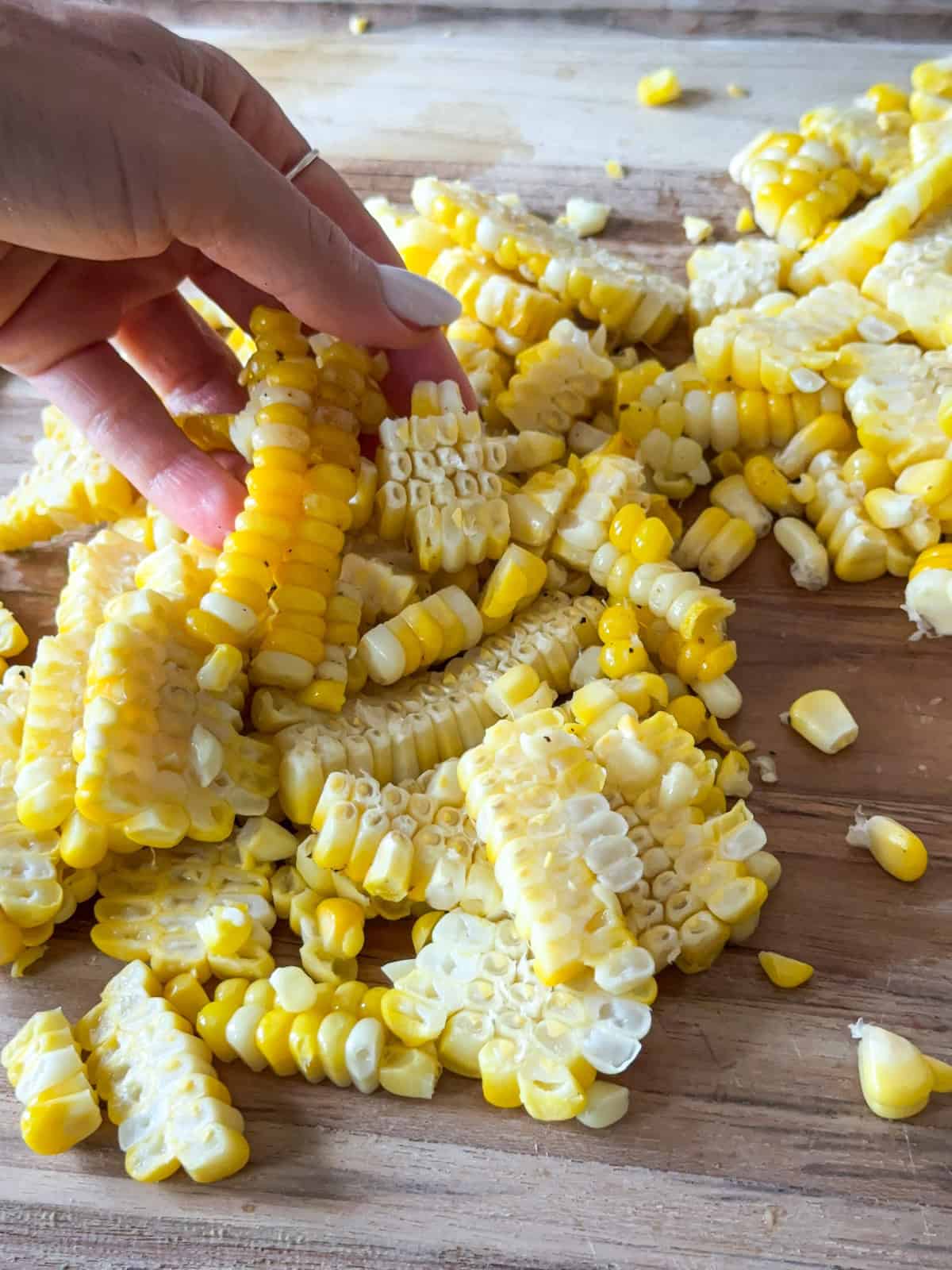 hand holding cooked corn.