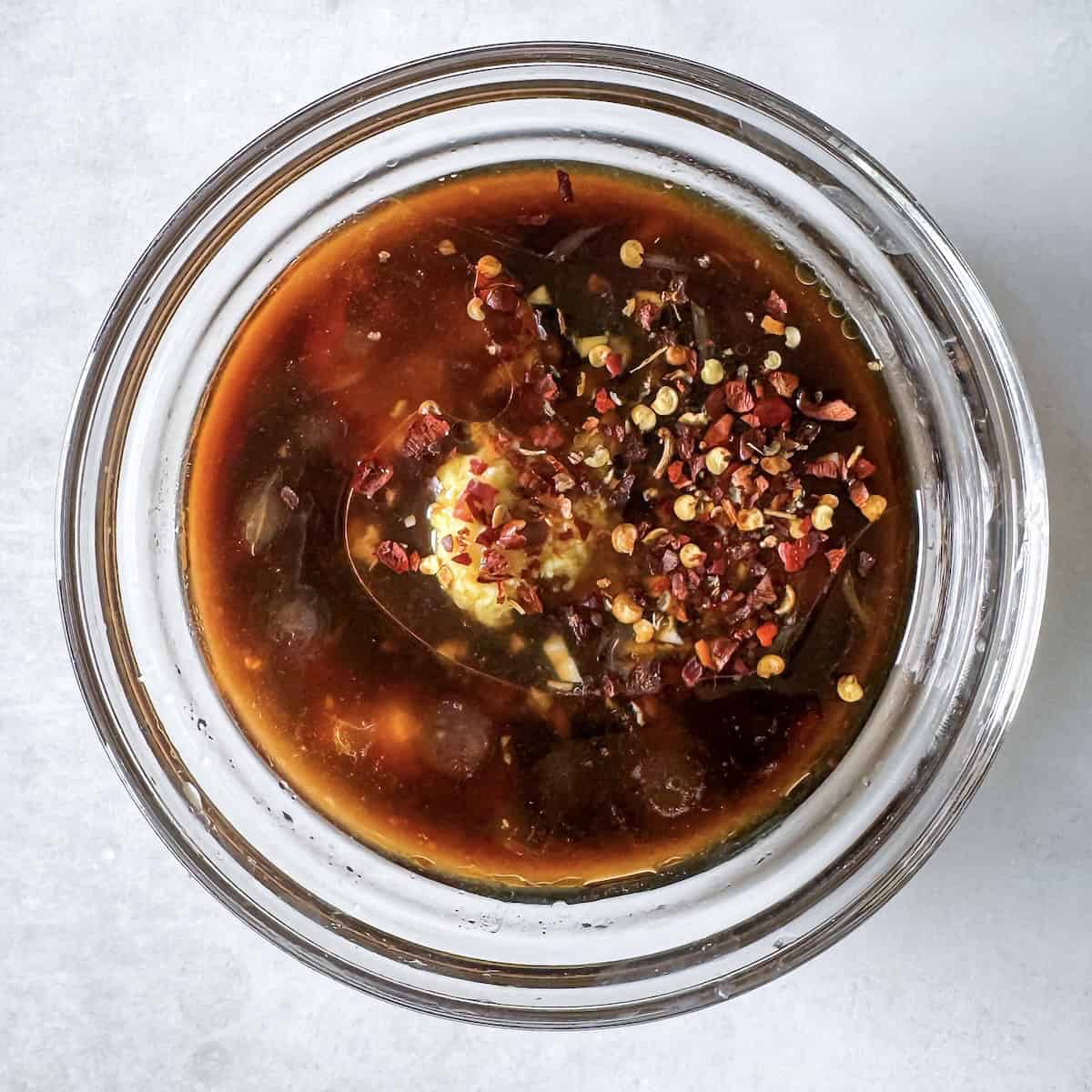 overhead view of ingredients for peanut lime dressing in a bowl.