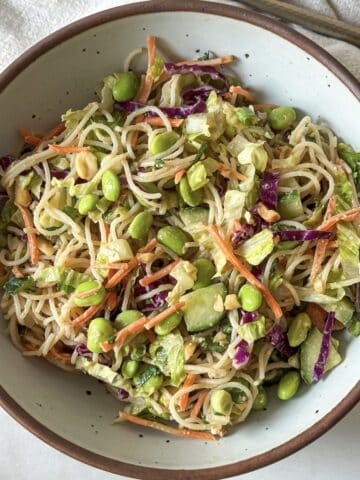 overhead view of spring roll in a bowl with edamame.