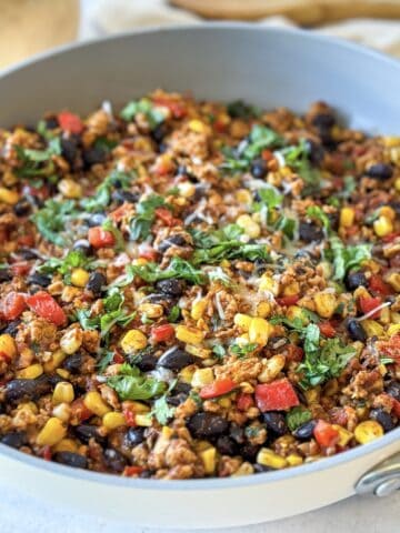 Turkey taco skillet with cilantro and cheese on top.