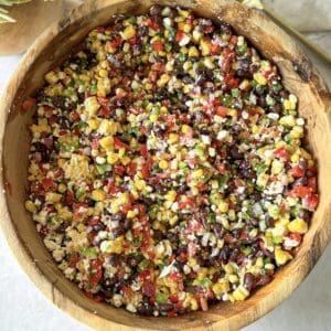 a wooden bowl with black bean and corn salsa overhead view.