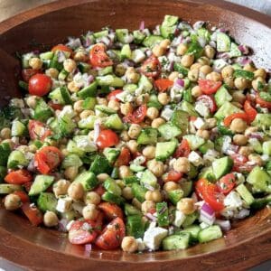 chickpea cucumber salad in a wooden bowl.