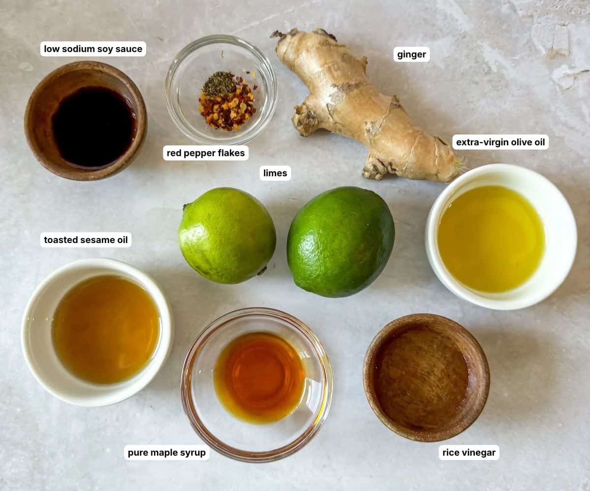 ginger lime dressing ingredients on a table in separate containers labeled.