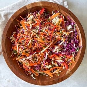 overhead view of asian crunch salad in a wooden bowl.