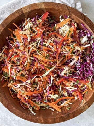 overhead view of asian crunch salad in a wooden bowl.