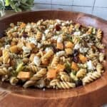 Fall pasta salad in a wooden bowl.