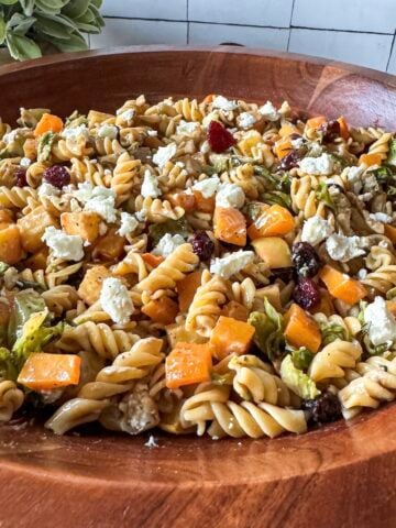 Fall pasta salad in a wooden bowl.