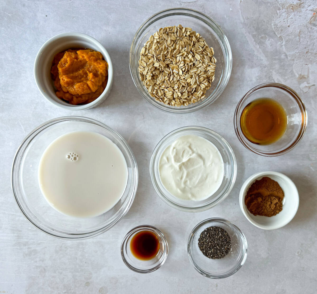 Ingredients for pumpkin pie overnight oats on a table.